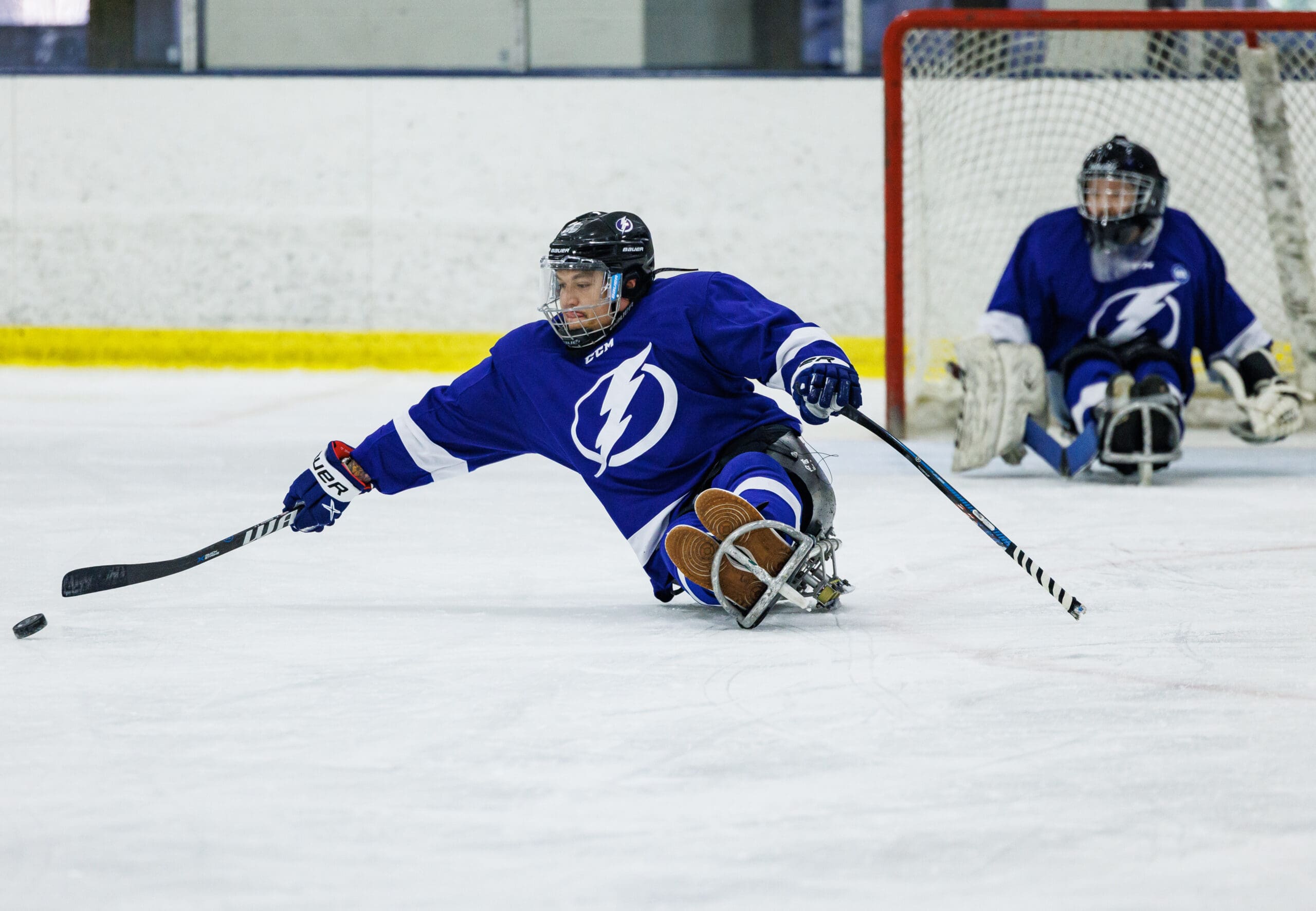 For Players:

The players will use two shortened sticks to move around the ice and play the puck or they may be pushed by a coach. The two skate blades under the sled allow the athlete to glide along the ice and they have a stick in each hand with metal picks at the knob which propel them to skate. The sticks are about 100 cm long with a 32cm long blade. Again, all customized to best fit the player.